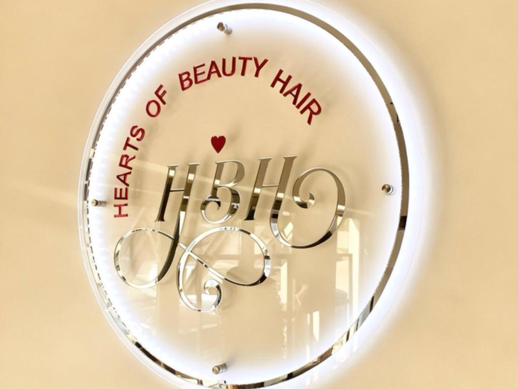 Clear acrylic sign layered in sliver and pink mirror acrylic logo lettering