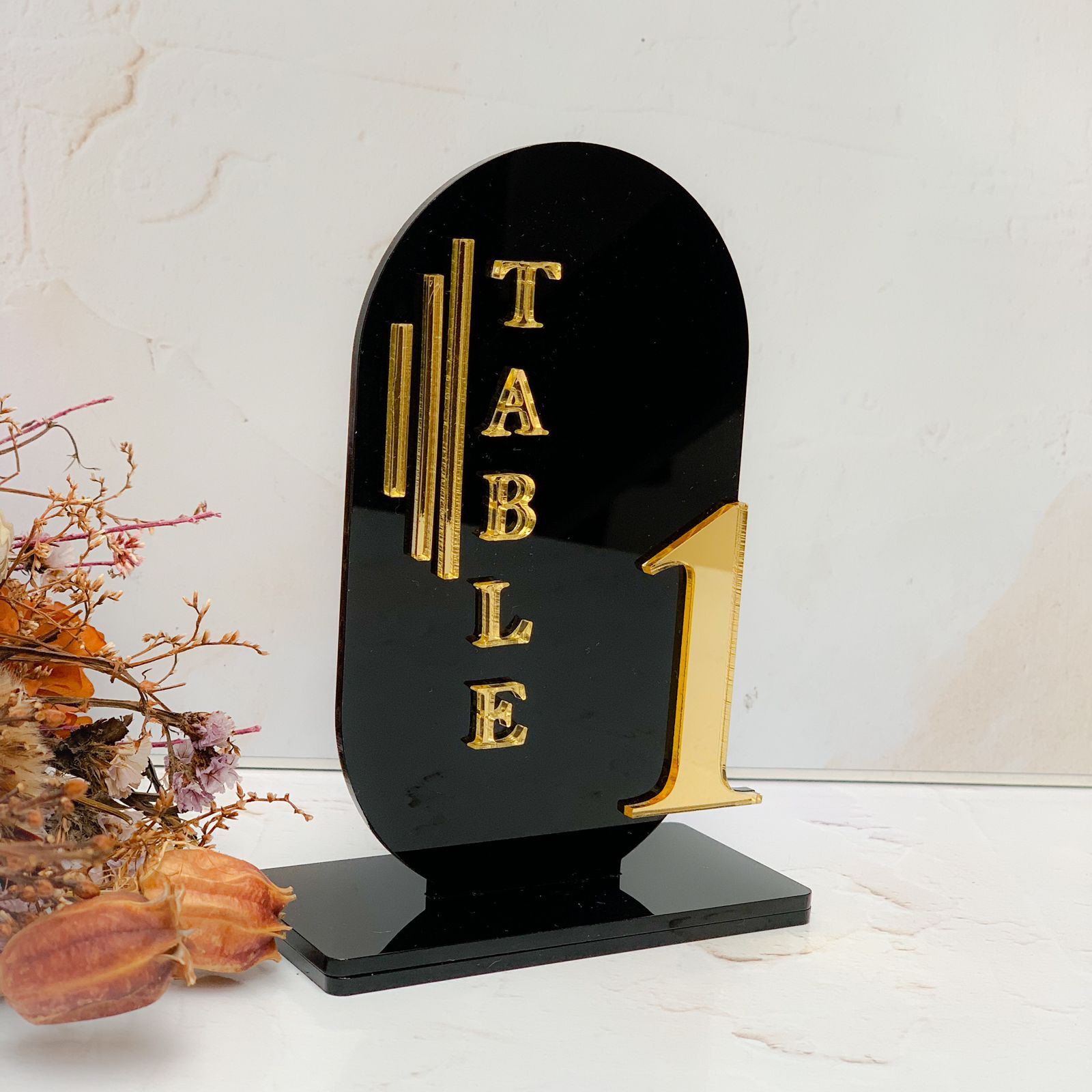 Black laser cut acrylic curved table number layered with gold mirror lettering and numbers 